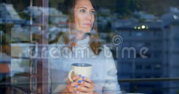 女人在喝咖啡而她的伴侣在背后拥抱视频的预览图