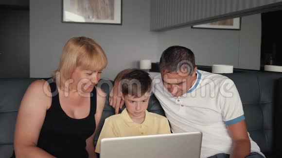幸福的家庭坐在沙发上和亲戚在网上聊天为人民服务的现代技术视频的预览图