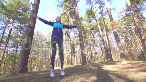 布鲁内特女孩在阳光明媚的森林里锻炼身体视频的预览图