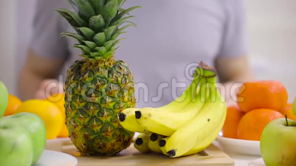 男性手把菠萝放到水果桌上视频的预览图