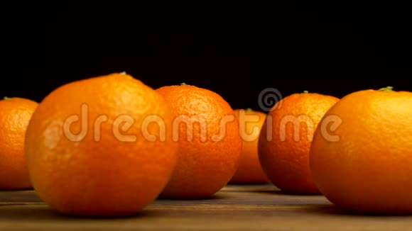一张黑色背景的木桌上摆着一种多汁的橘子从这张桌子上可以看到冰霜般的清新和凉爽视频的预览图