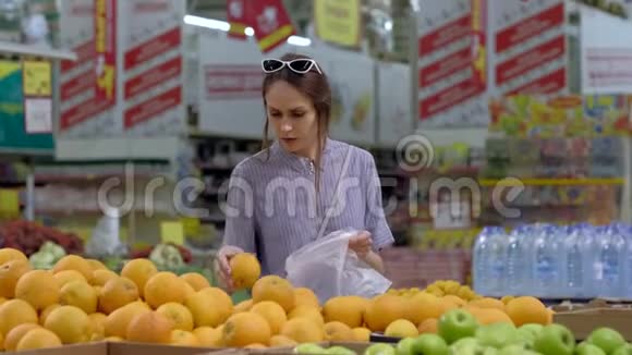 一位年轻女子在超市买橘子视频的预览图