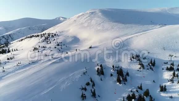 一台大型吹雪机正在清理一座山的山丘令人惊叹的背景是清晨的阳光4K视频的预览图