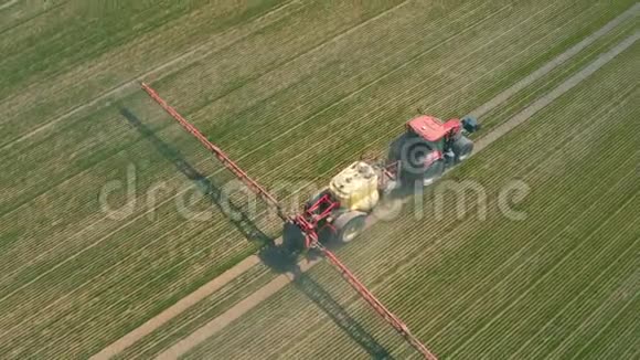 灌溉农田的拖拉机的鸟瞰图视频的预览图