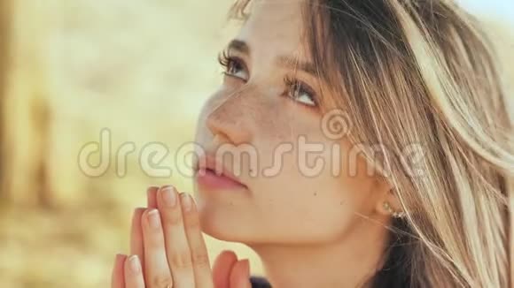 一个18岁的金发女孩用双手交叉祈祷视频的预览图