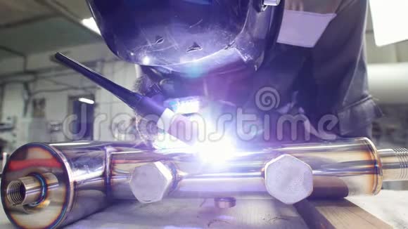 微型焊接操作人员在工厂使用碳化金属电火花雕刻设备带着面罩视频的预览图