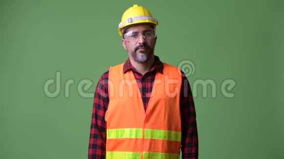 英俊的波斯胡子男建筑工人戴着防护眼镜双臂交叉视频的预览图
