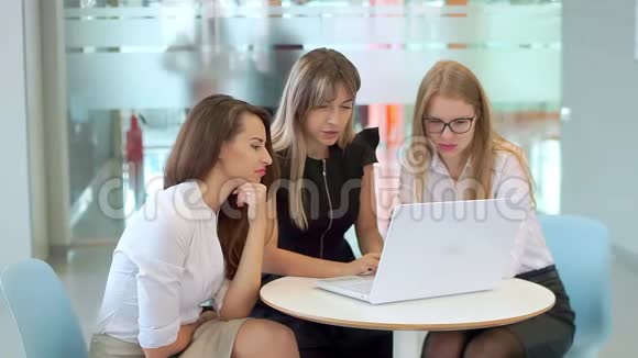 年轻迷人的女孩在商务会议上看着笔记本电脑正在说话视频的预览图