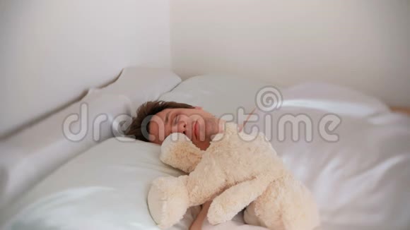 年轻的父亲爸爸醒来发现一只玩具熊在床上经过一个艰难的夜晚与一个孩子视频的预览图