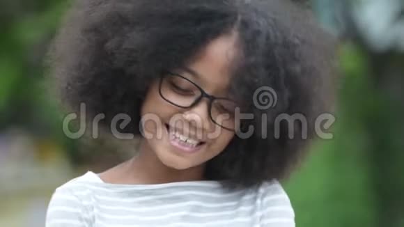 年轻快乐的非洲女孩留着非洲头发闭着眼睛在户外的街道上放松视频的预览图