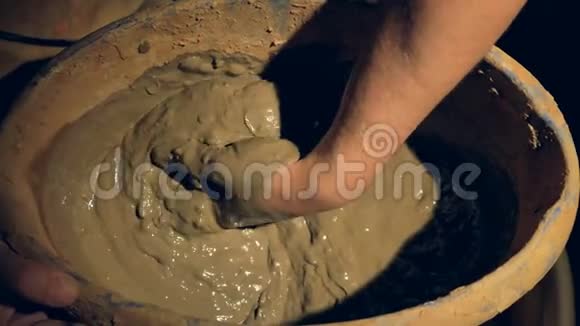 陶工手上的一个特写混合了湿粘土视频的预览图