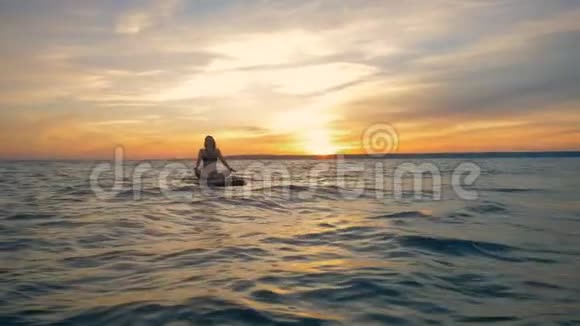 海上日落船上漂浮着一位优雅的女士视频的预览图
