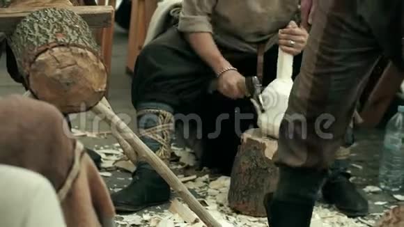 穿着传统服装的木匠用斧子剁碎了木制的保视频的预览图