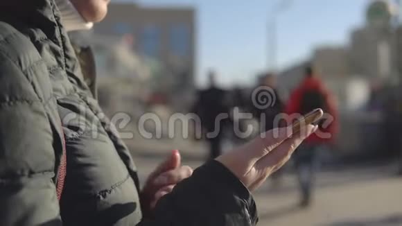 在繁忙的街道上有电话的年轻女子视频的预览图