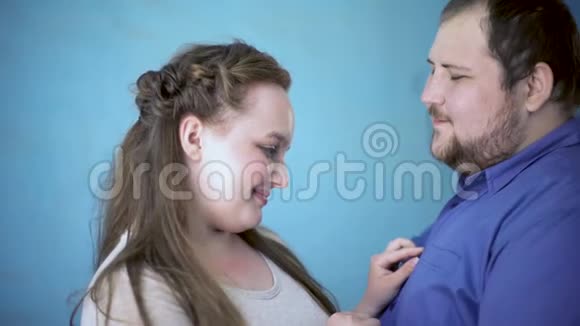 胖男人亲吻漂亮女朋友的脸颊约会调情浪漫的爱情视频的预览图
