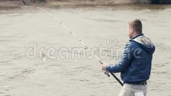渔夫捕鱼钓鱼者从钓竿上的鱼钩上钓到鱼视频的预览图