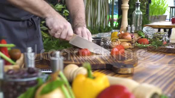 厨师用刀切番茄做食物成分背景一个拿刀切新鲜番茄的男人视频的预览图