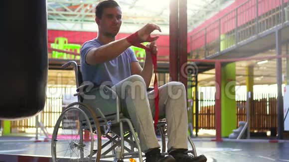 坐轮椅的残疾人手上有伤拳击磁带慢节奏视频的预览图