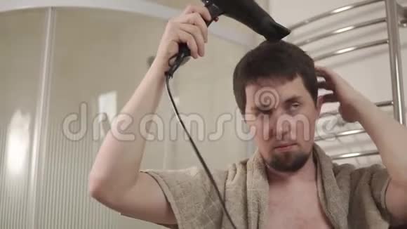 淋浴后男人正在擦干头发视频的预览图