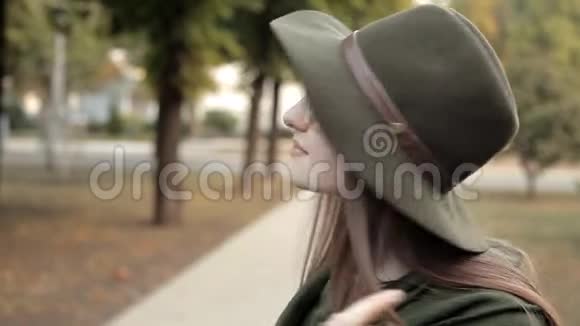 神秘的年轻女孩走在秋天的公园里她的微笑和情感公园秋天姑娘视频的预览图