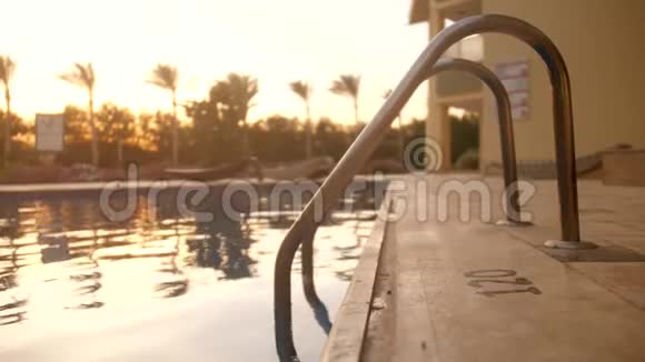 日落时豪华热带别墅游泳池的4k慢镜头视频的预览图