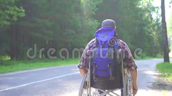 坐轮椅的残疾人坐在高速公路上慢节奏视频的预览图