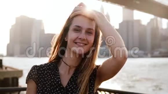 慢动作特写照片快乐的欧洲女孩走向镜头微笑布鲁克林大桥河景视频的预览图