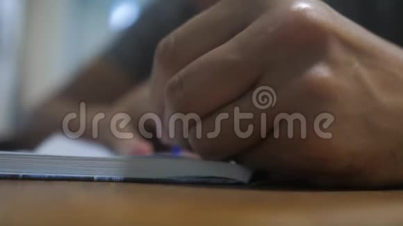 人在笔记本上写字男人手写记事本概念商业教育男人在笔记本上做笔记视频的预览图