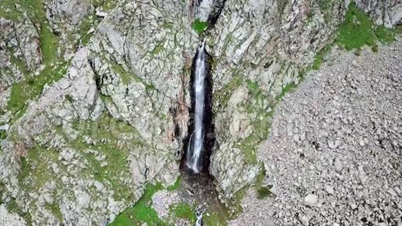 瀑布鸟瞰岩石绿草和绿色植物之间的瀑布视频的预览图