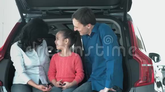 家人在说话坐在汽车后备箱上视频的预览图