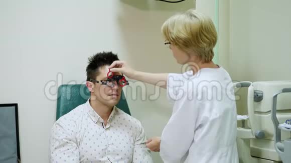 女性验光师为有光镜的病人做视力检查验光师试验框架视觉视频的预览图
