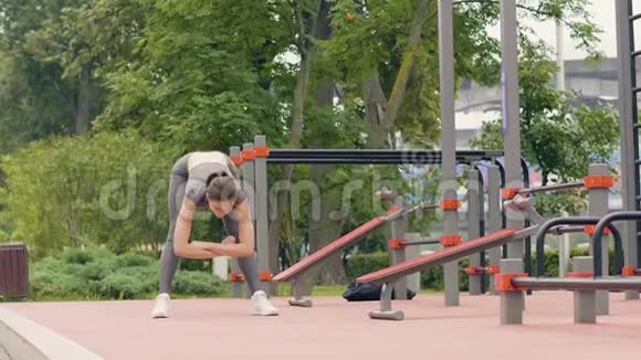 运动妇女在夏季公园户外训练时做斜坡运动视频的预览图