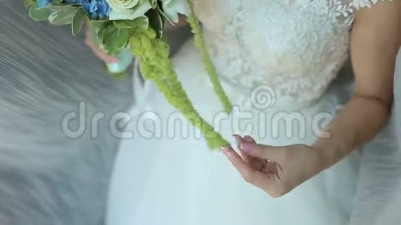 新娘捧着婚礼花束轻轻地抚摸着鲜花视频的预览图