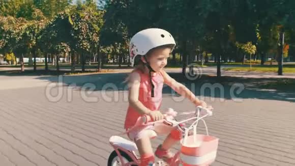 戴安全帽的快乐孩子在户外骑自行车视频的预览图