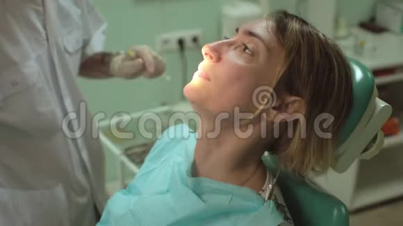 牙医在牙科诊所给美丽的女性病人注射视频的预览图