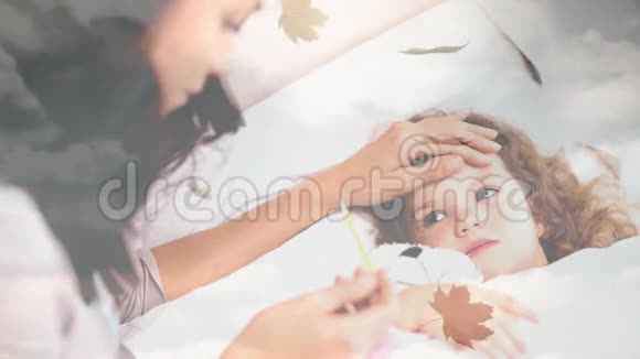 秋天的落叶和女人用体温计检查她女儿的发烧情况视频的预览图