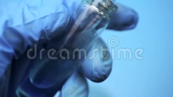 医生将一种蓝色液体拨入实验室吸管视频的预览图