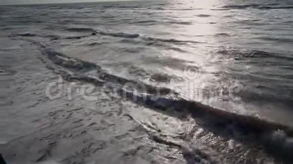 灰色的海洋在夏天在多风的天气力量波浪泡沫形成在海岸和冲浪太阳之路地平线蓝天视频的预览图