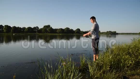 渔夫从一个木墩上向湖里扔了一个渔具视频的预览图