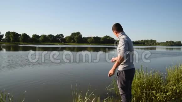 渔夫从一个木墩上向湖里扔了一个渔具视频的预览图