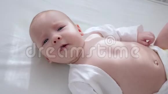 新生婴儿在阳光下躺在床上视频的预览图