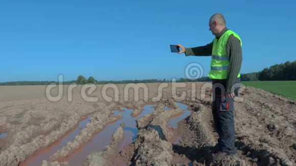 农民检查潮湿的田野视频的预览图