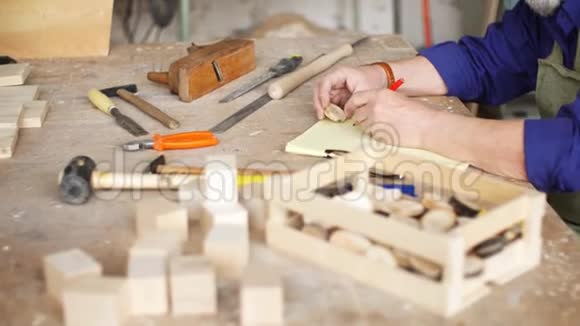 工匠坐在木桌上用各种乐器进行手工制作视频的预览图