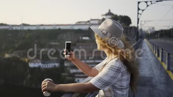 戴帽子穿衣服的女士在桥上自拍视频的预览图