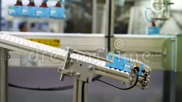 在工厂内自动机器将输送带上的果汁盒关闭媒体小机器人视频的预览图