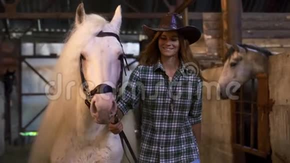 女孩把马从摊子里拿出来肖像那个女孩正对着照相机微笑视频的预览图