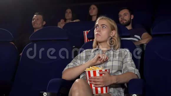 年轻漂亮的女人微笑着在电影院竖起大拇指视频的预览图