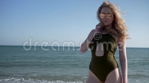 暑假身穿泳装戴墨镜的卷发女士合影视频的预览图