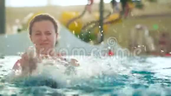 在公共室内水上乐园泳池里的少女视频的预览图