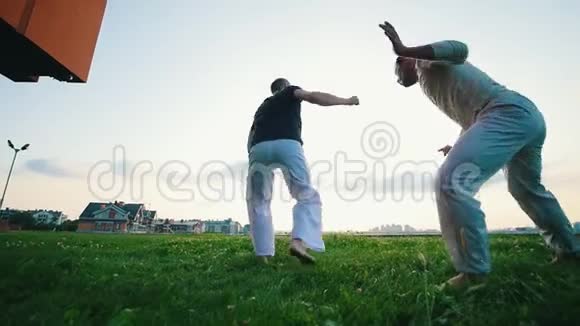 两个壮汉在夏日夕阳下的草地上打了一架视频的预览图